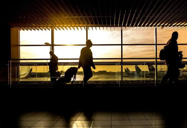 travel men in the airport with their luggage