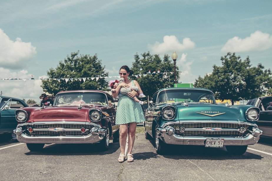 baby girl with mommy and retro cars