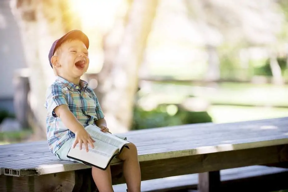 Boy laughing reading